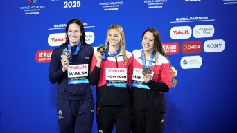 Summer McIntosh and Mary-Sophie Harvey smile together with their competitor Alex Walsh