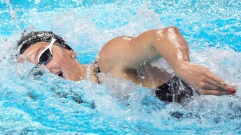 Summer McIntosh takes a breath while swimming freestyle