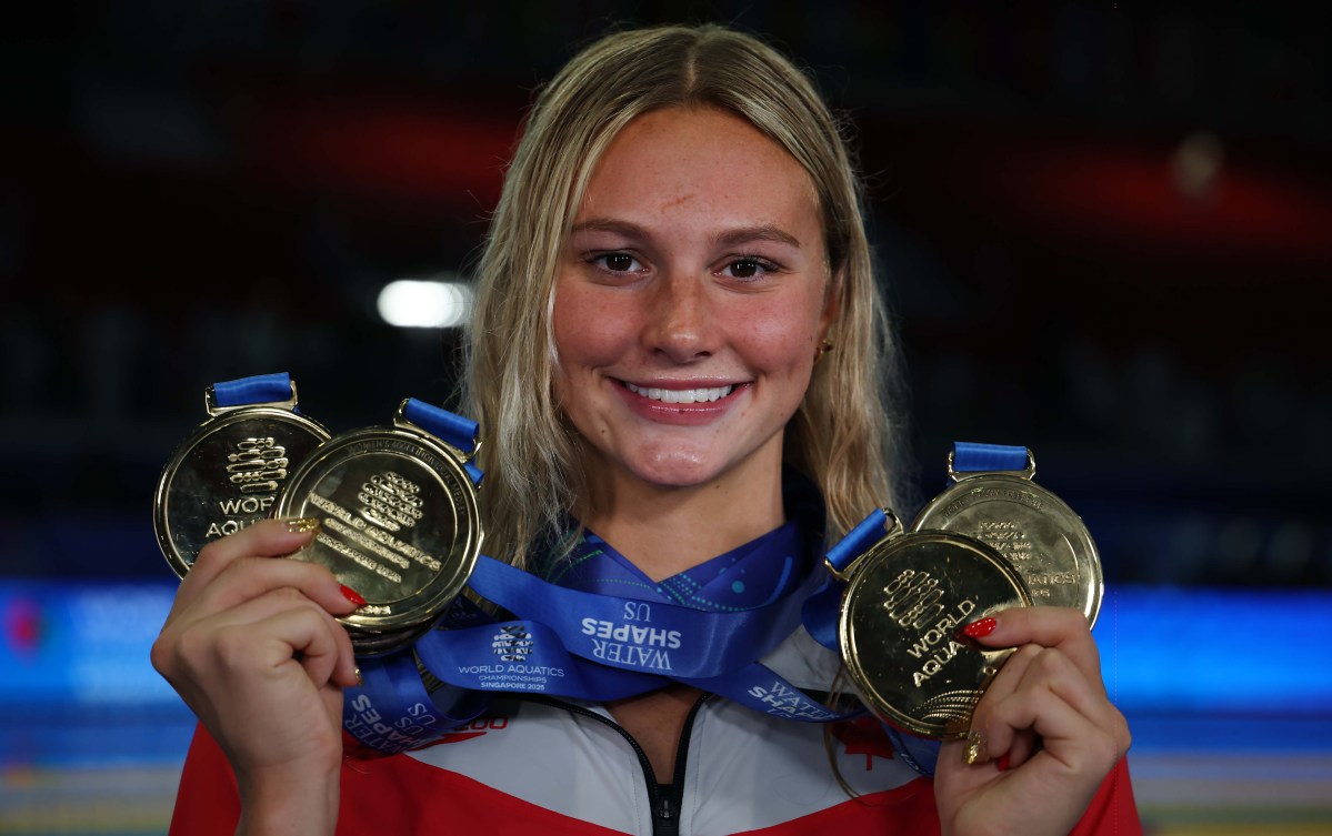 Summer McIntosh displays her gold medals from the 2025 World Aquatics Championships