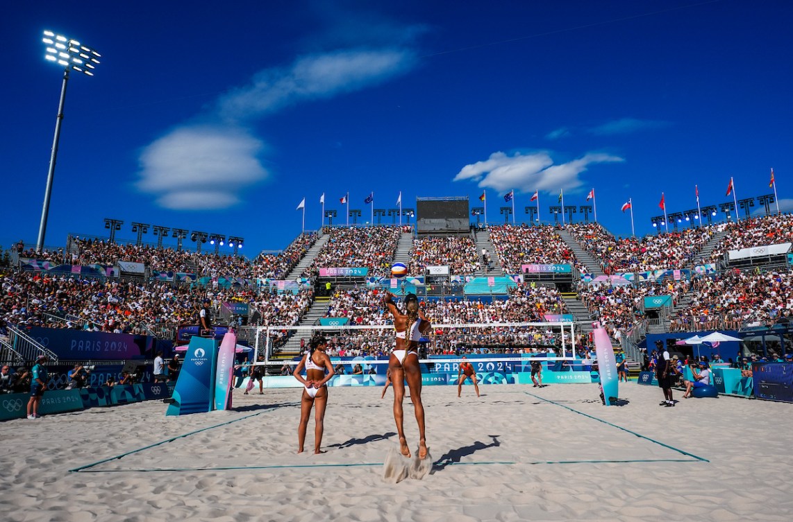 Brandie Wilkerson serves in front of the Paris 2024 crowds and a blue sky
