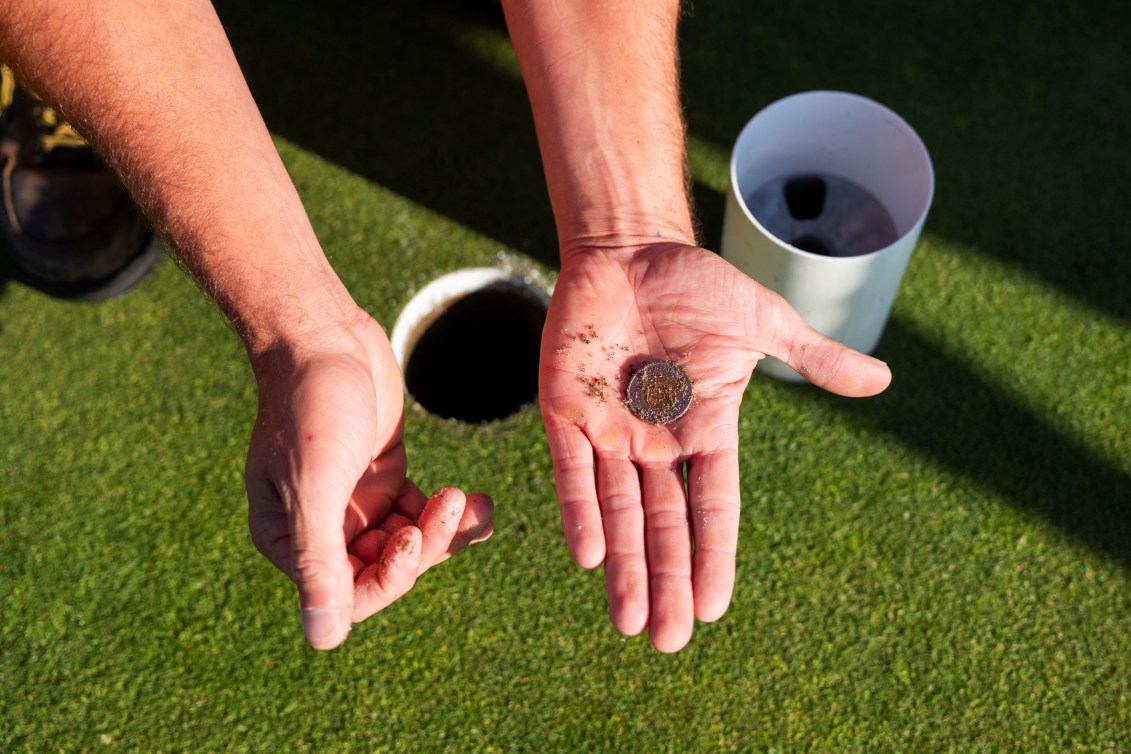 A Canadian toonie is removed from the 18th hole at the 2025 CPKC Women's Open