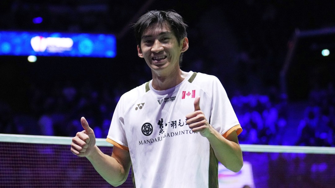 Victor Lai wearing a white shirt gives two thumbs up