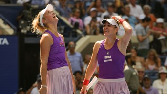 Dressed in purple tops and pink skirts, Gabriela Dabrowski and Erin Routliffe react with disbelief on their faces