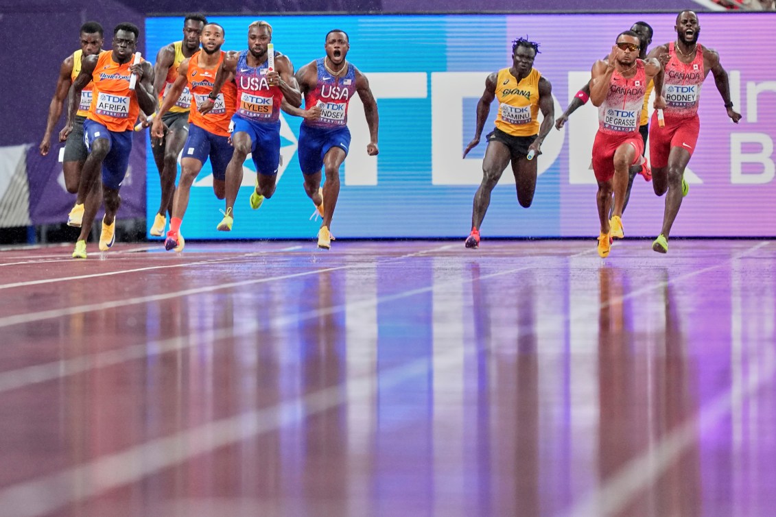 Rain on the track as relay teams make baton exchanges
