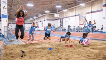 Children participate in long jump at Bell Starting Line