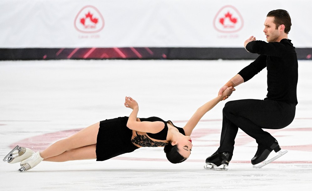 Dressed in black, Lia Pereira and Trennt Michaud perform a death spiral
