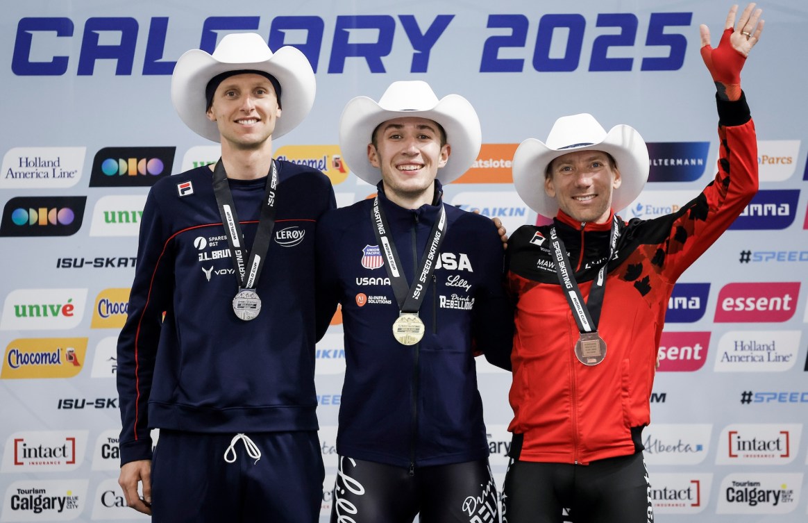Casey Dawson, centre, of the United States, celebrates his victory with second place finisher Norway's Sander Eitrem, left, and third place finisher Canada's Ted-Jan Bloemen on the podium following the men's 5000-metre competition during ISU World Cup speed skating in Calgary, Alta., Friday, Nov. 21, 2025. THE CANADIAN PRESS/Jeff McIntosh