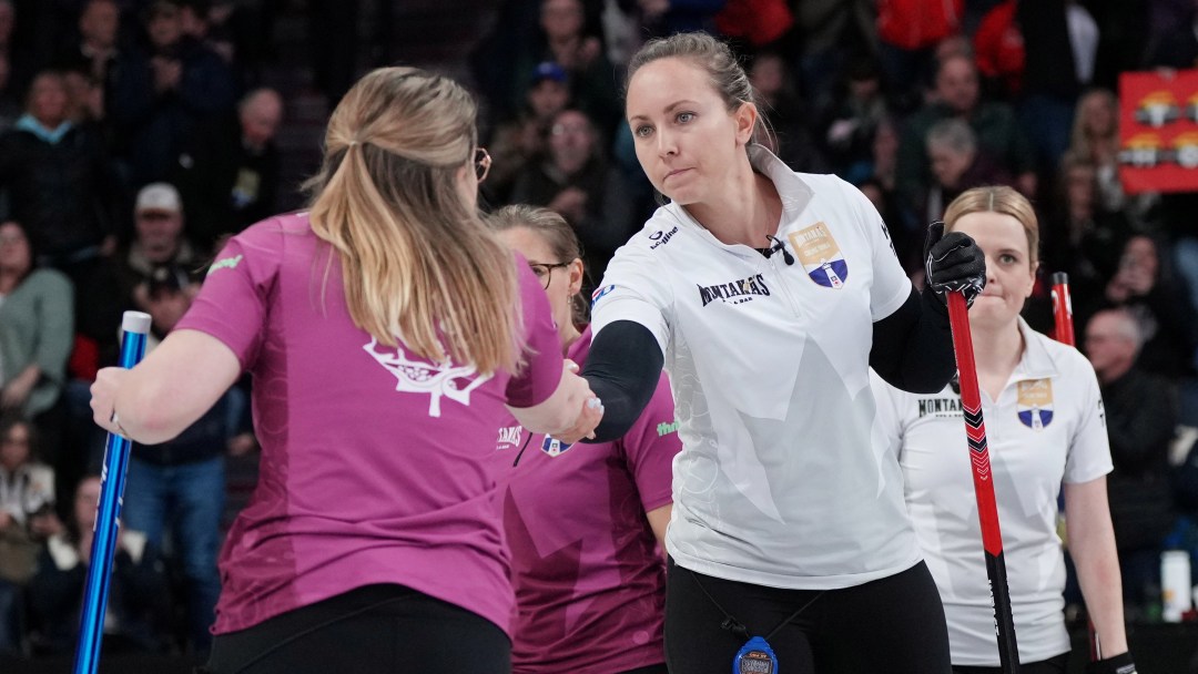 Rachel Homan in a white shirt shakes the hand of Christina Black in a magenta shirt