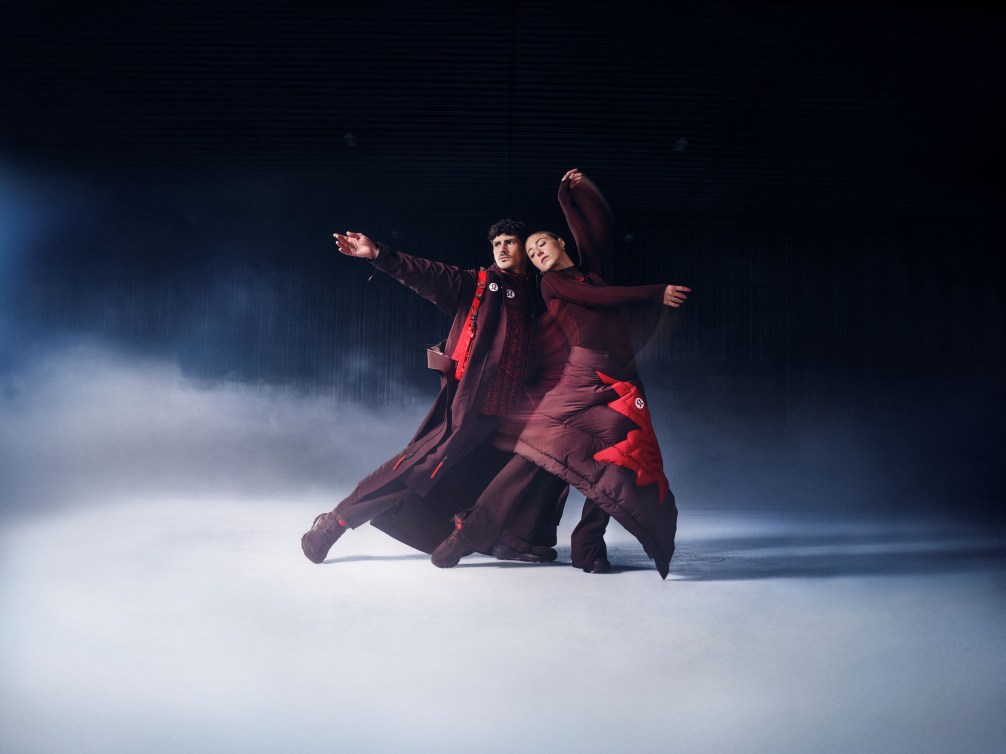 Piper Gilles and Paul Poirier dressed in burgundy pose on an ice rhink