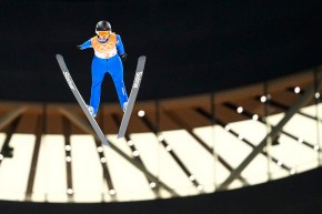 Ski jumper Abigail Strate flies through the air at Beijing 2022.