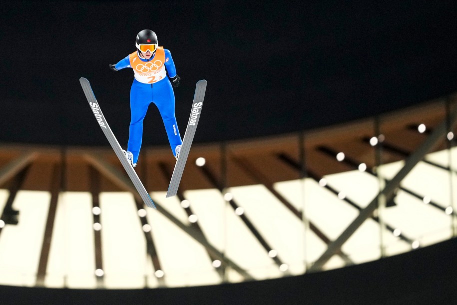 Ski jumper Abigail Strate flies through the air at Beijing 2022.