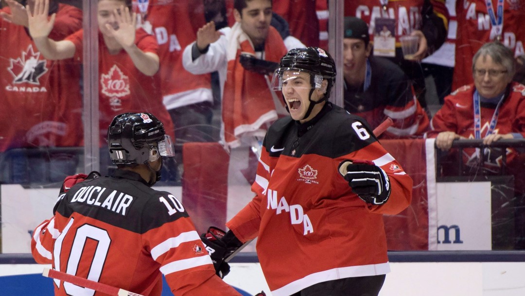 Two hockey players in red jerseys celebrate