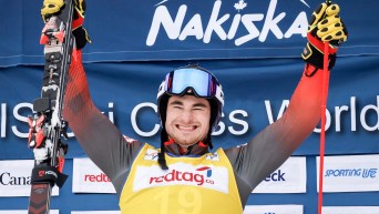 Canada's Reece Howden celebrates his victory on the podium follwoing the men's final of a World Cup ski cross event at Nakiska Ski Resort in Kananaskis, Alta., Saturday, Jan. 20, 2024.THE CANADIAN PRESS/Jeff McIntosh