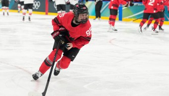 Daryl Watts competes in ice hockey.