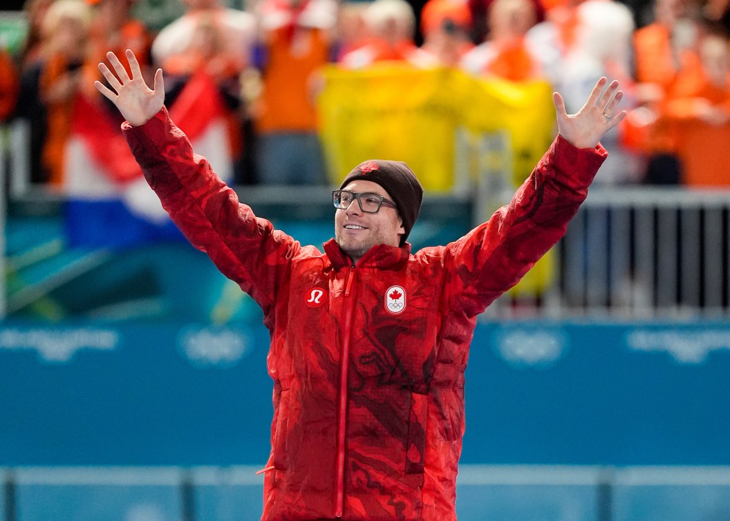 Laurent Dubreuil raises his arms in the air.