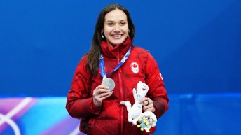 Team Canada’s Courtney Sarault celebrates a silver medal in women's 1000m Short Track Speed Skating