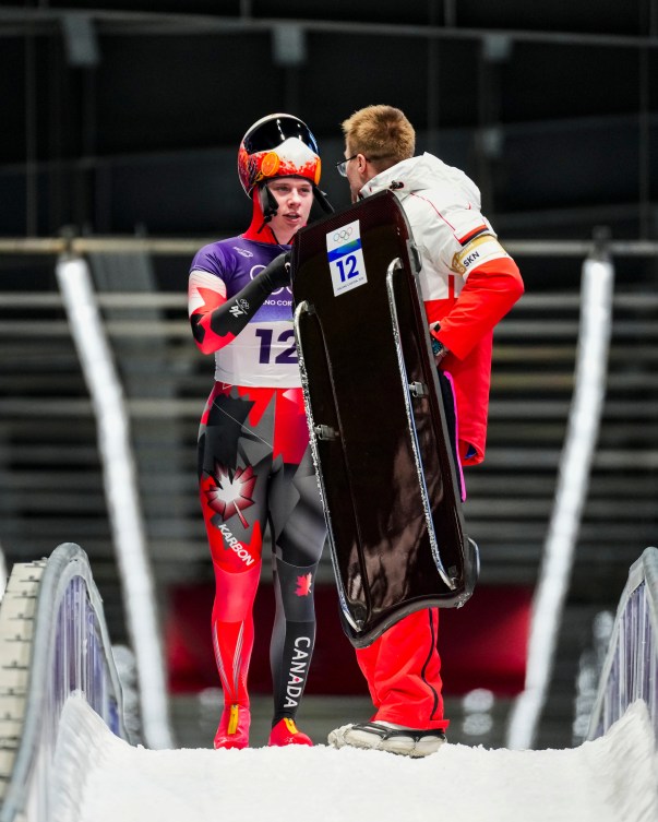 Hallie Clarke speaks to her coach after the first run