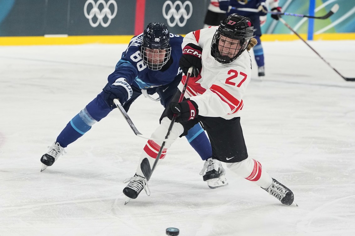 Emma Maltais shoots on goal past Finland's Ronja Savolainen