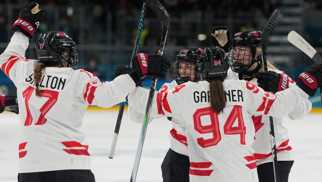 Kristin O'Neill and her teammates celebrate after scoring