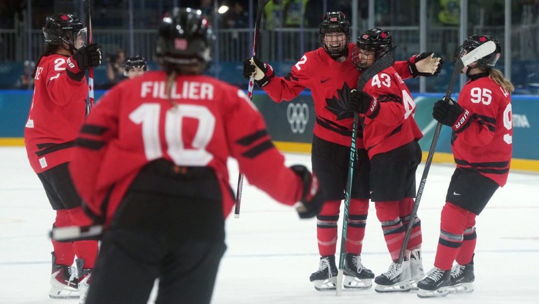 Team Canada’s Claire Thompson raises arms and stick to celebrates her goal with teammates Sophie Jaques, Sarah Fillier, Kristin O’Neill, and Daryl Watts.