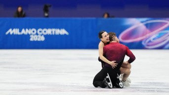 Lia Pereira and Trennt Michaud hug on the ice