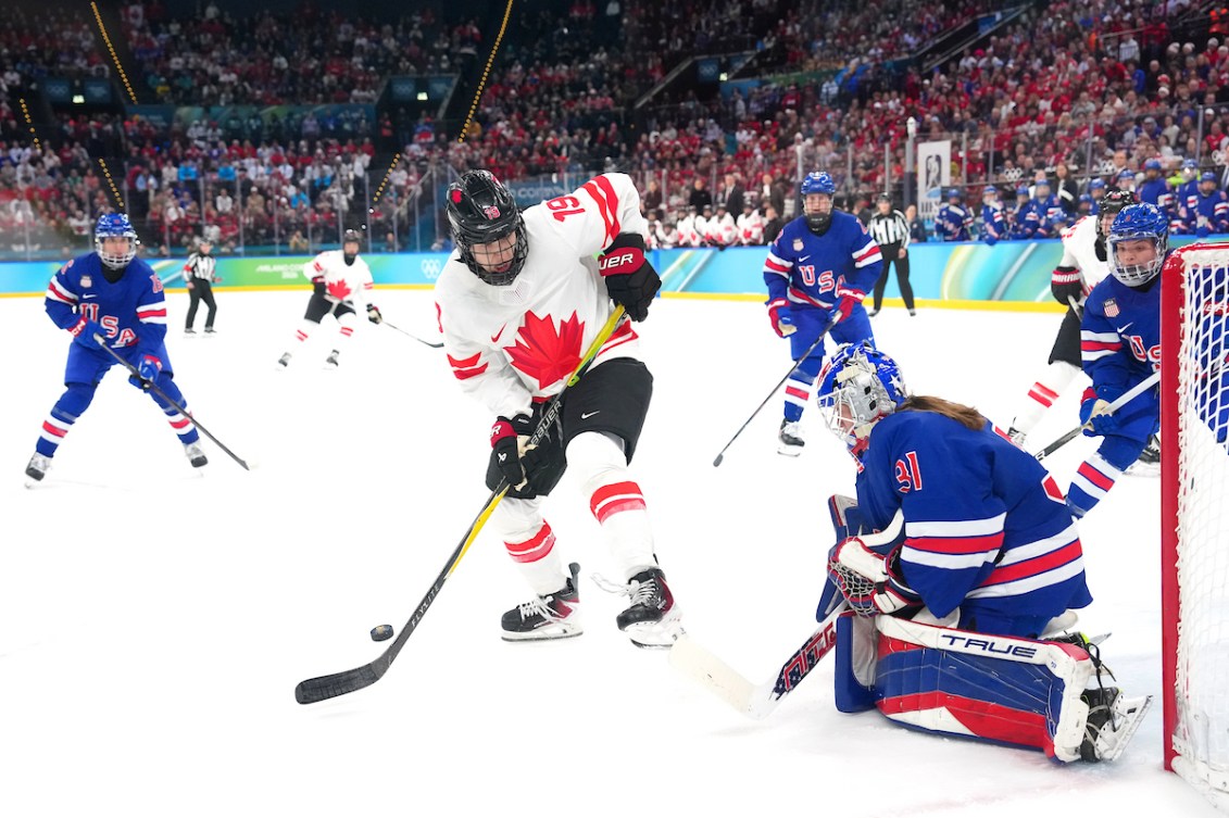 Brianne Jenner tries to control a rebound off goaltender Aerin Frankel