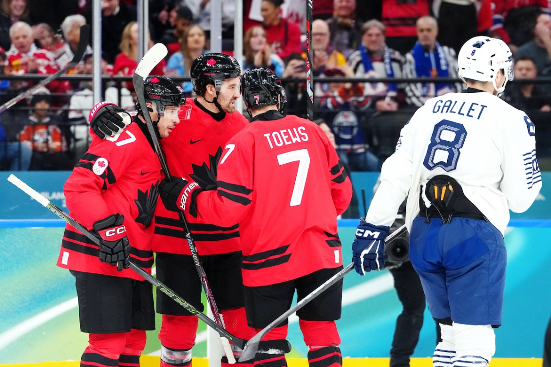 Devon Toews celebrates a goal with teammates