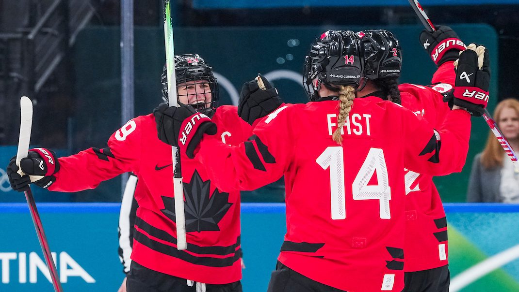 Marie-Philip Poulin celebrates her goal with Sophie Jaques and Renata Fast