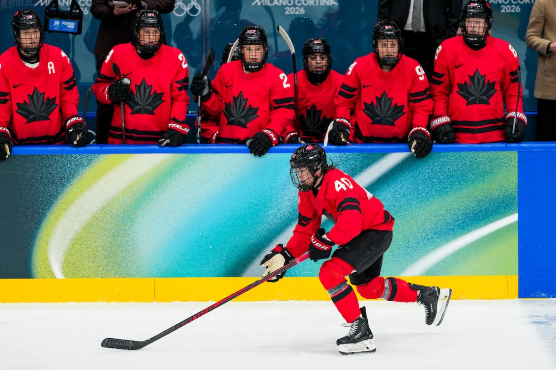 Team Canada's Blayre Turnbull (40) skates in front of the bench