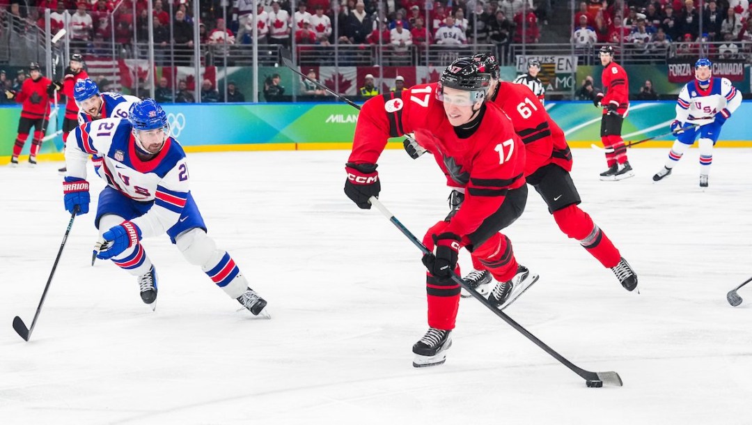 Macklin Celebrini shoots the puck