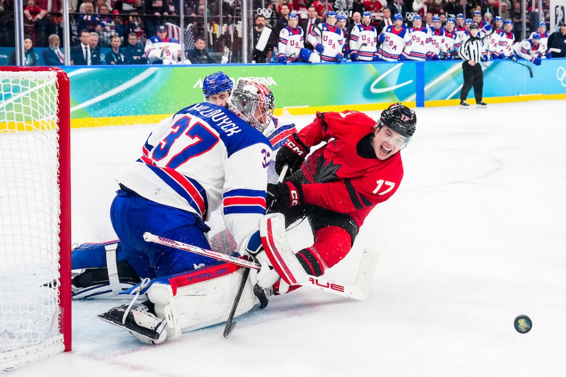 Macklin Celebrini crashes the net of United States' goaltender.