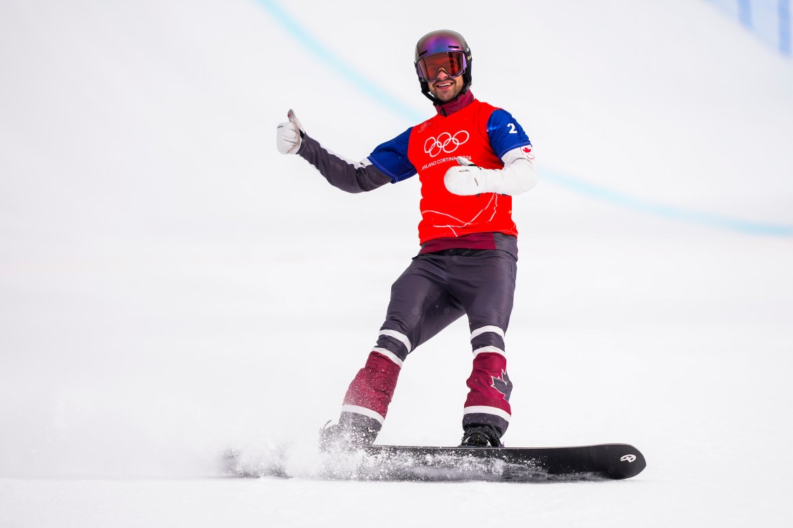 Eliot Grondin celebrates after winning his 1/8 final heat in snowboard cross