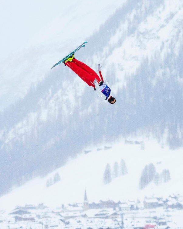 Lewis Irving soars through snowy sky during competition.