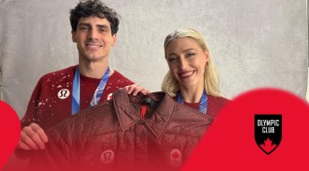 Piper and Paul smiling and holding a Team Canada Jacket