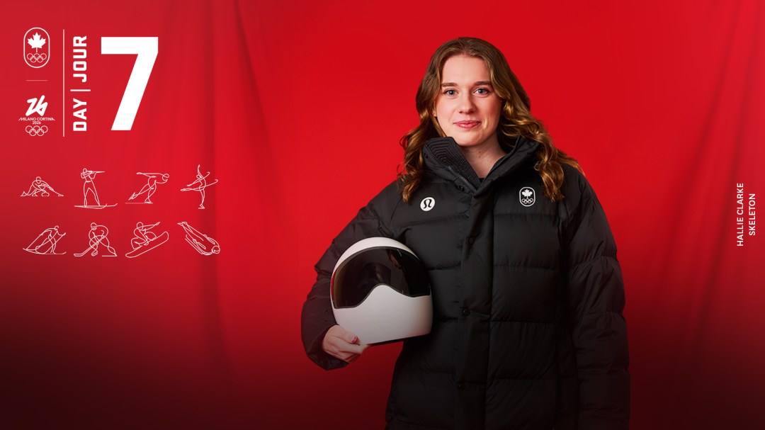 Skeleton athlete Hallie Clarke, holding helmet and smiling for photo.