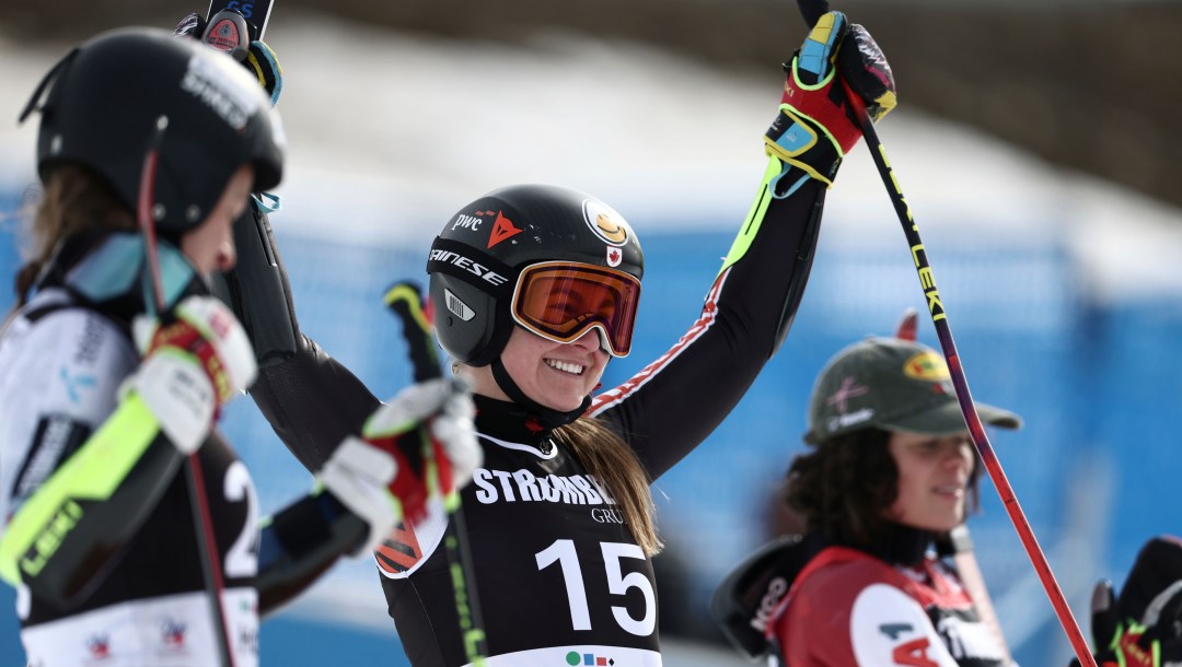 Valerie Genier raises her arms in celebration