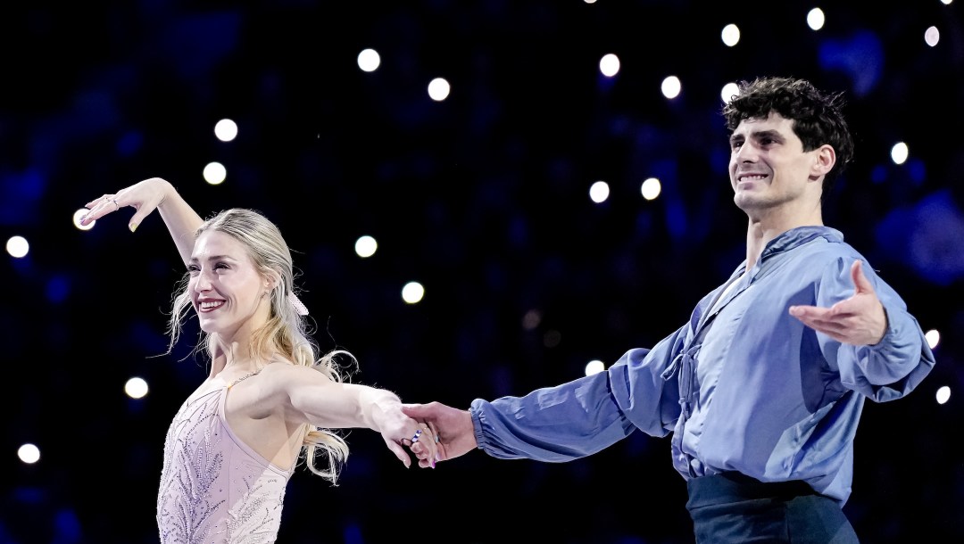 Piper Gilles and Paul Poirier from Canada wave before the medal ceremony.