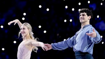 Piper Gilles and Paul Poirier from Canada wave before the medal ceremony.