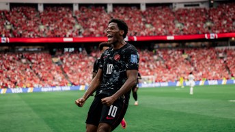 Jonathan David celebrates scoring against Qatar on Thursday.