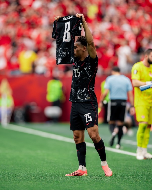 Nathan Saliba holds up an Ismael Kone jersey after scoring on Thursday.