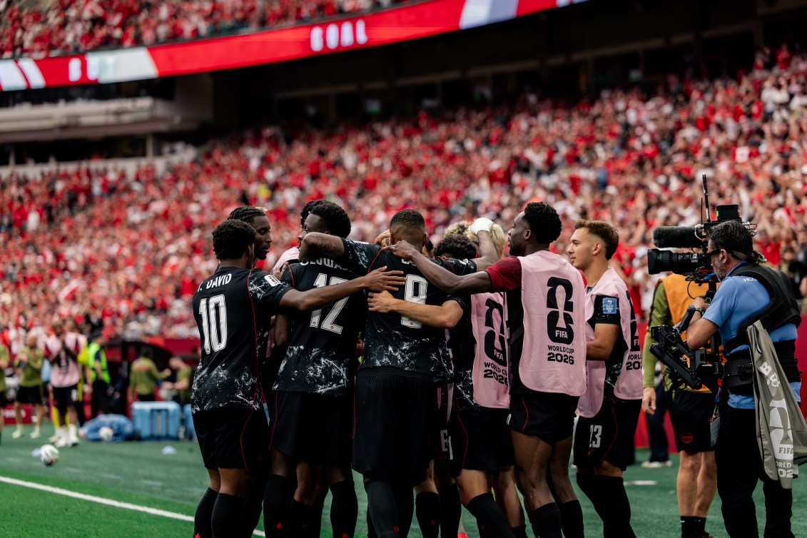 Canada players celebrate scoring a goal against Qatar in a FIFA World Cup match on Thursday.