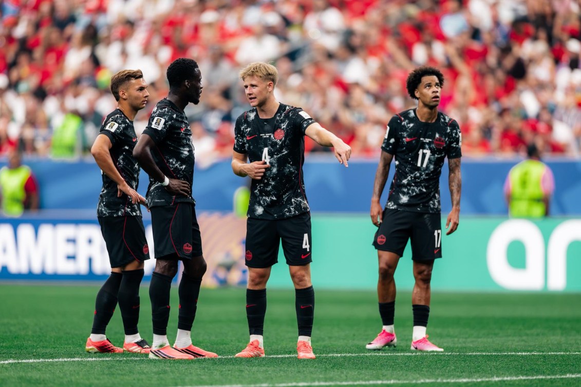 Luc de Fougerolles talks to Canadian teammates in the Round of 16 match against Morocco.