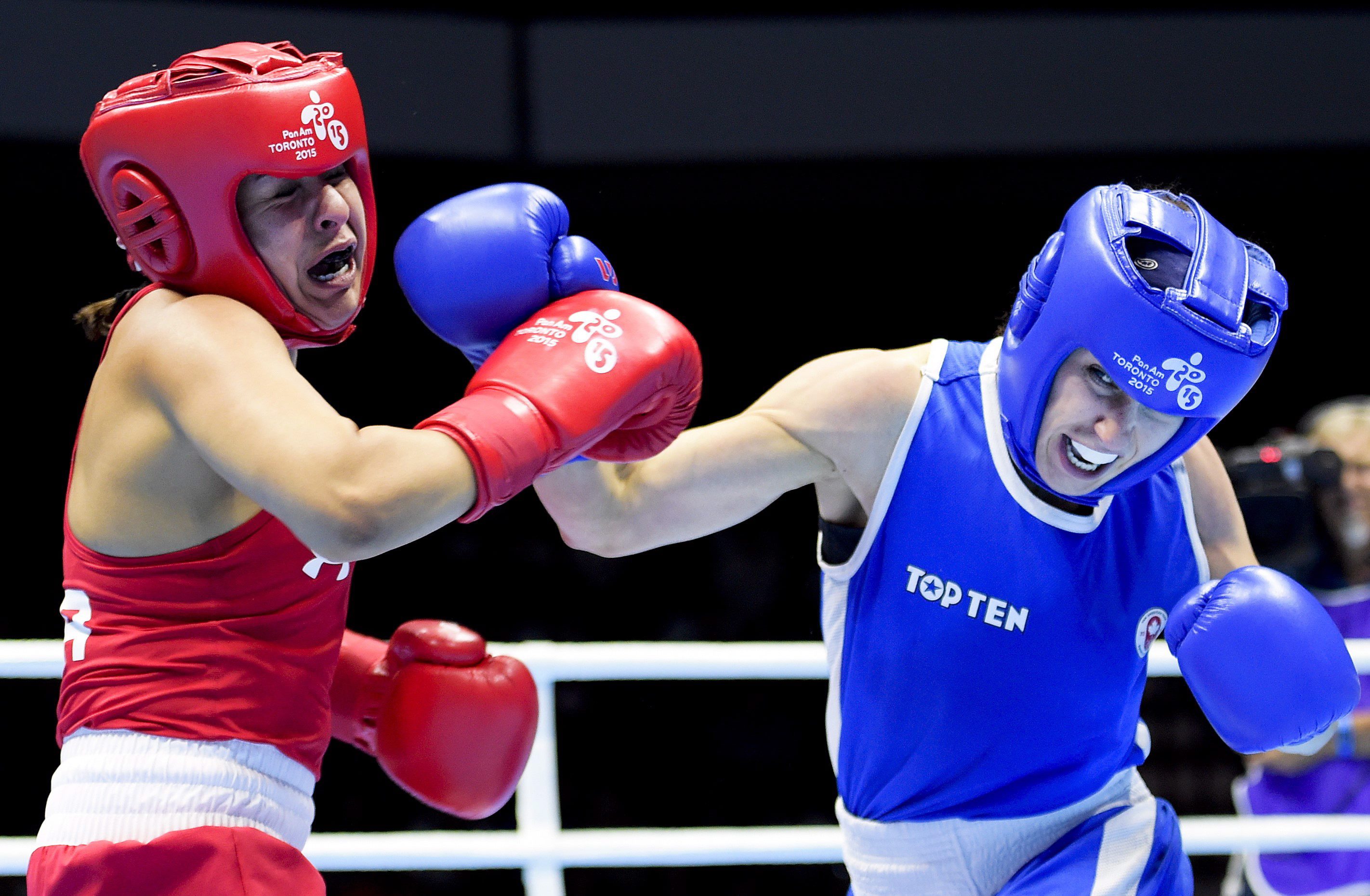 Many Bujold, right, of Canada competes against Marlen Esparza, of the United States, in the women's 48-51kg flyweight gold medal boxing final during the Pan American Games in Oshawa, Ont., on Saturday, July 25, 2015. Bujold won gold. THE CANADIAN PRESS/Nathan Denette