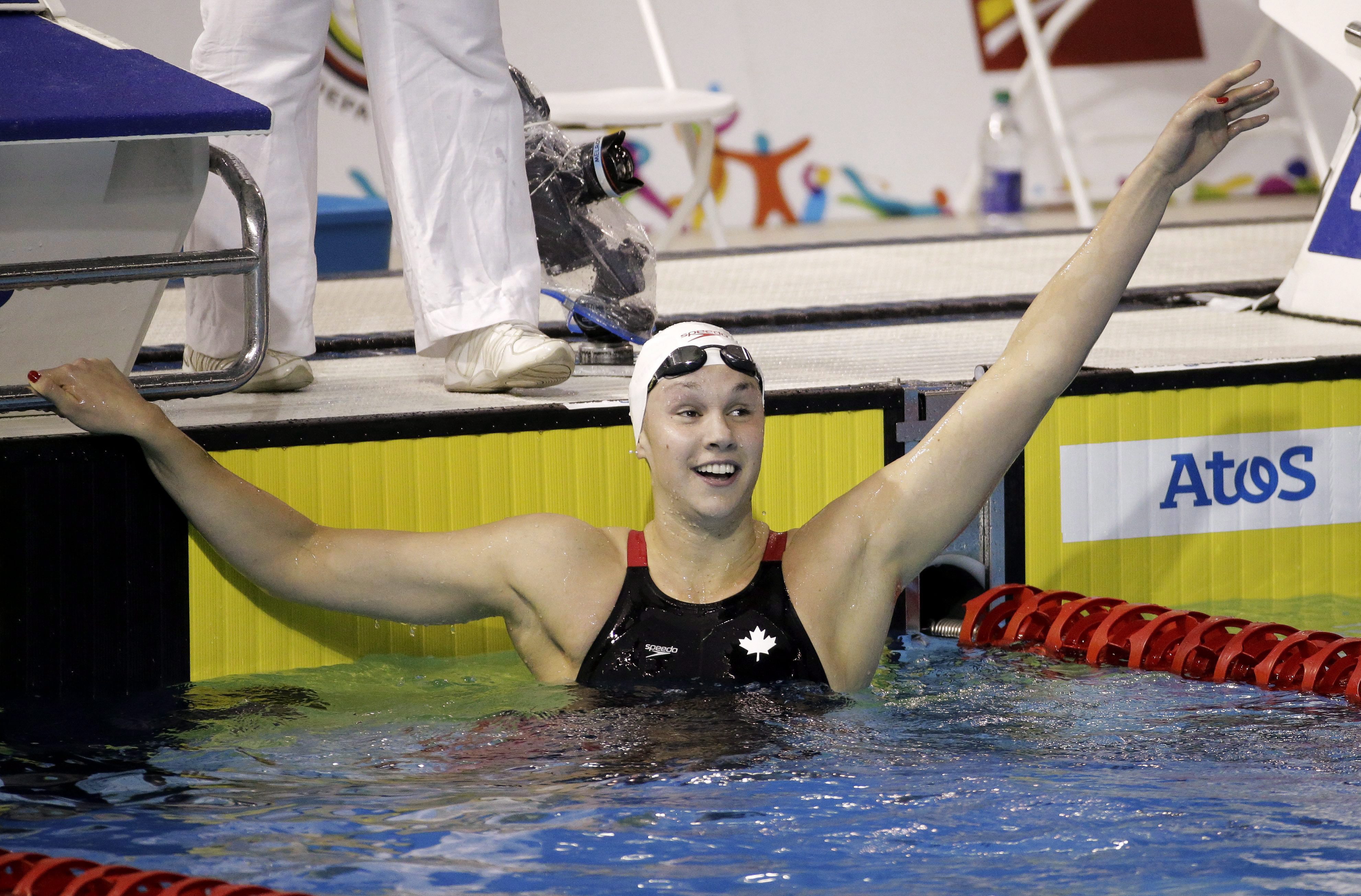 Chantal Van Landeghem of Canada celebrates after winning the gold medal in the women's 100-meter freestyle swimming event at the Pan Am Games Tuesday, July 14, 2015, in Toronto. (AP Photo/Mark Humphrey)