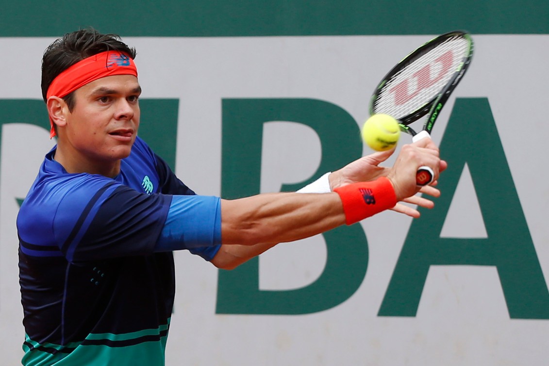 Milos Raonic effectue un retour contre le Serbe Janko Tipsarevic au premier tour du Grand Chelem de Roland-Garros, le 23 mai 2016. (AP Photo/Alastair Grant)