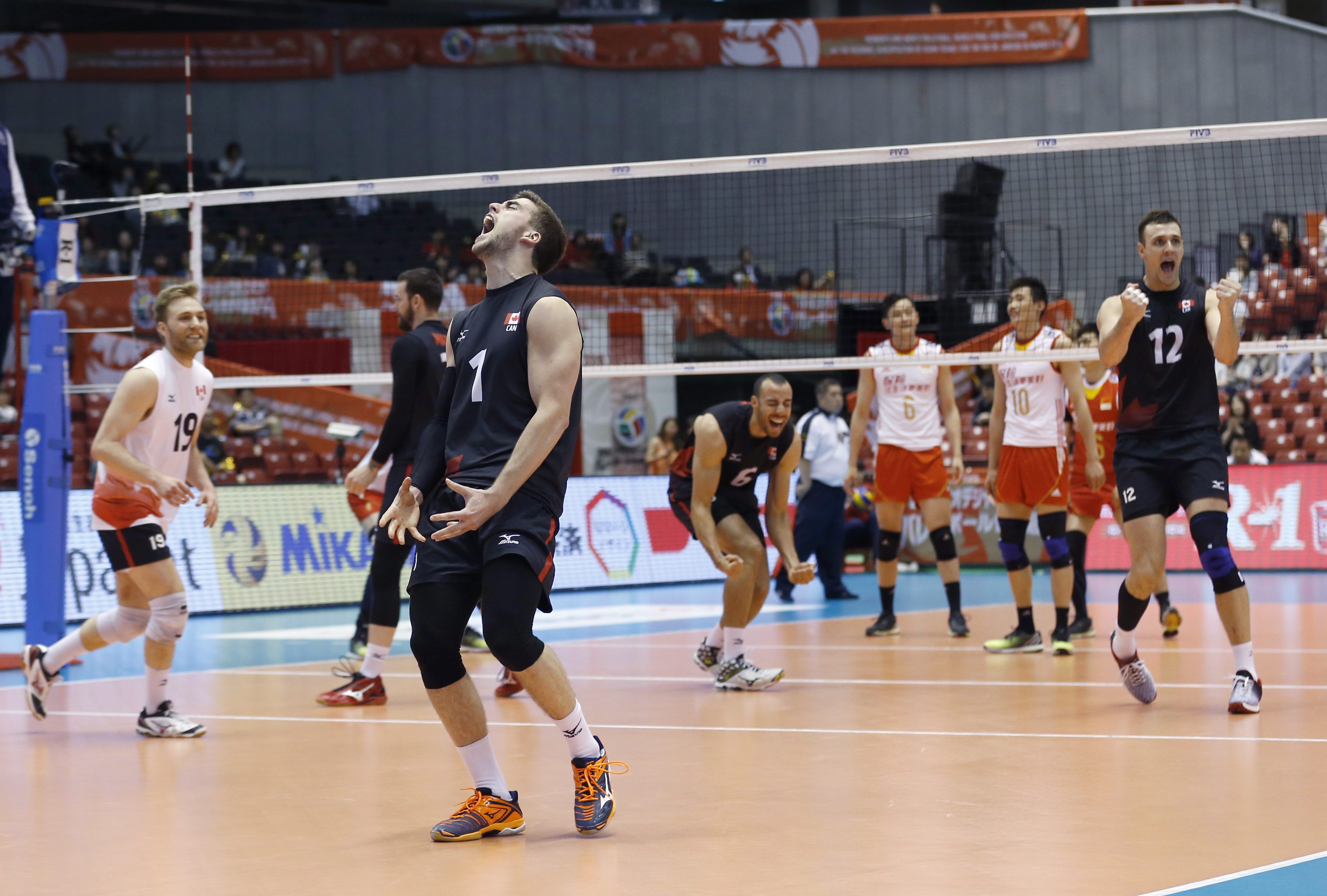 Tyler Sanders (1), Cameron Bann (19), Gavin Schmitt (12), Justin Duff (6) of Canada celebrate after their win over China during their Men's Volleyball World Olympic qualification tournament match in Tokyo, Sunday, June 5, 2016. (AP Photo/Shizuo Kambayashi)