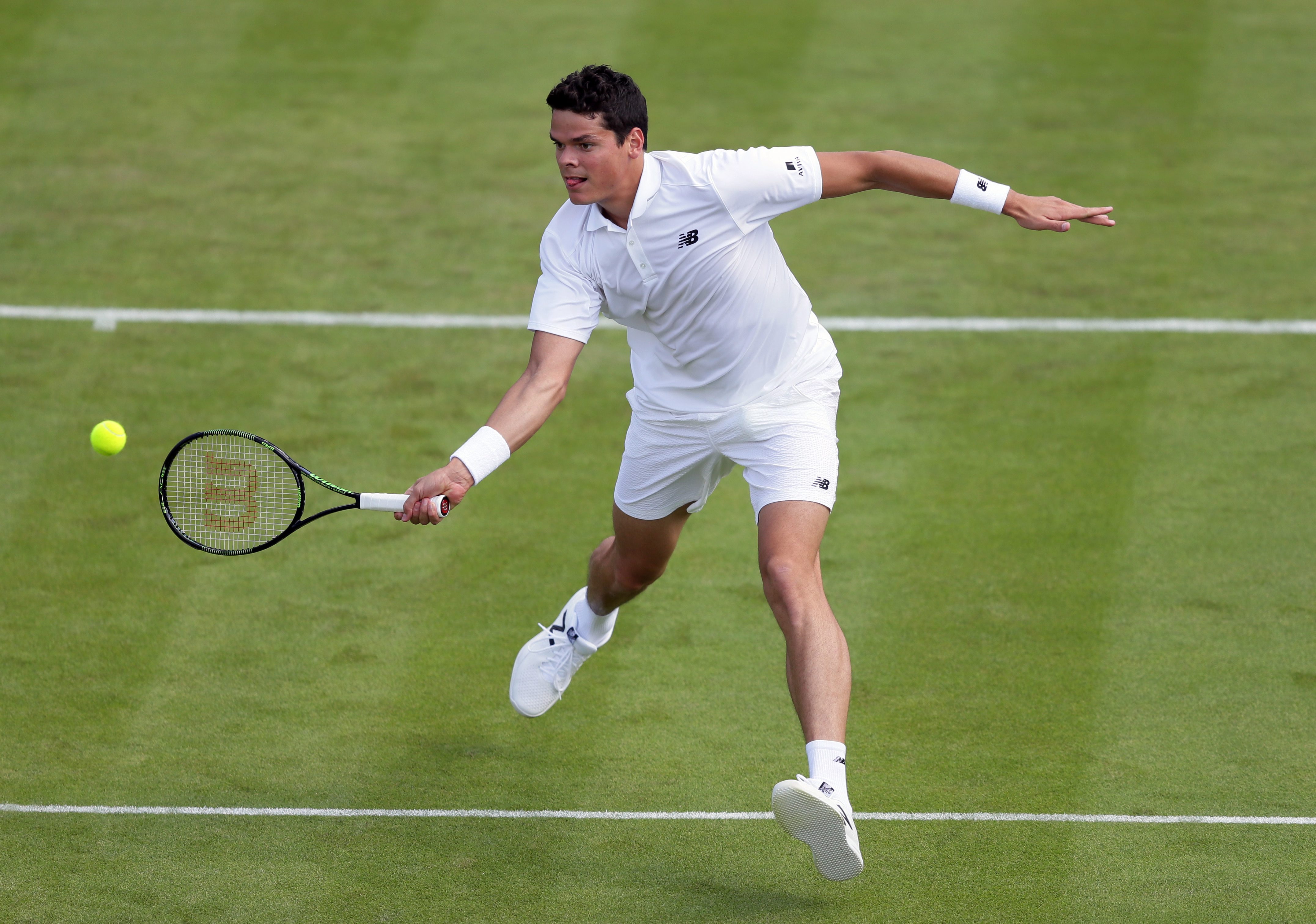 Milos Raonic of Canada plays a return to Pablo Carreno Busta of Spain during their men's singles match on day one of the Wimbledon Tennis Championships in London, Monday, June 27, 2016. (AP Photo/Tim Ireland)