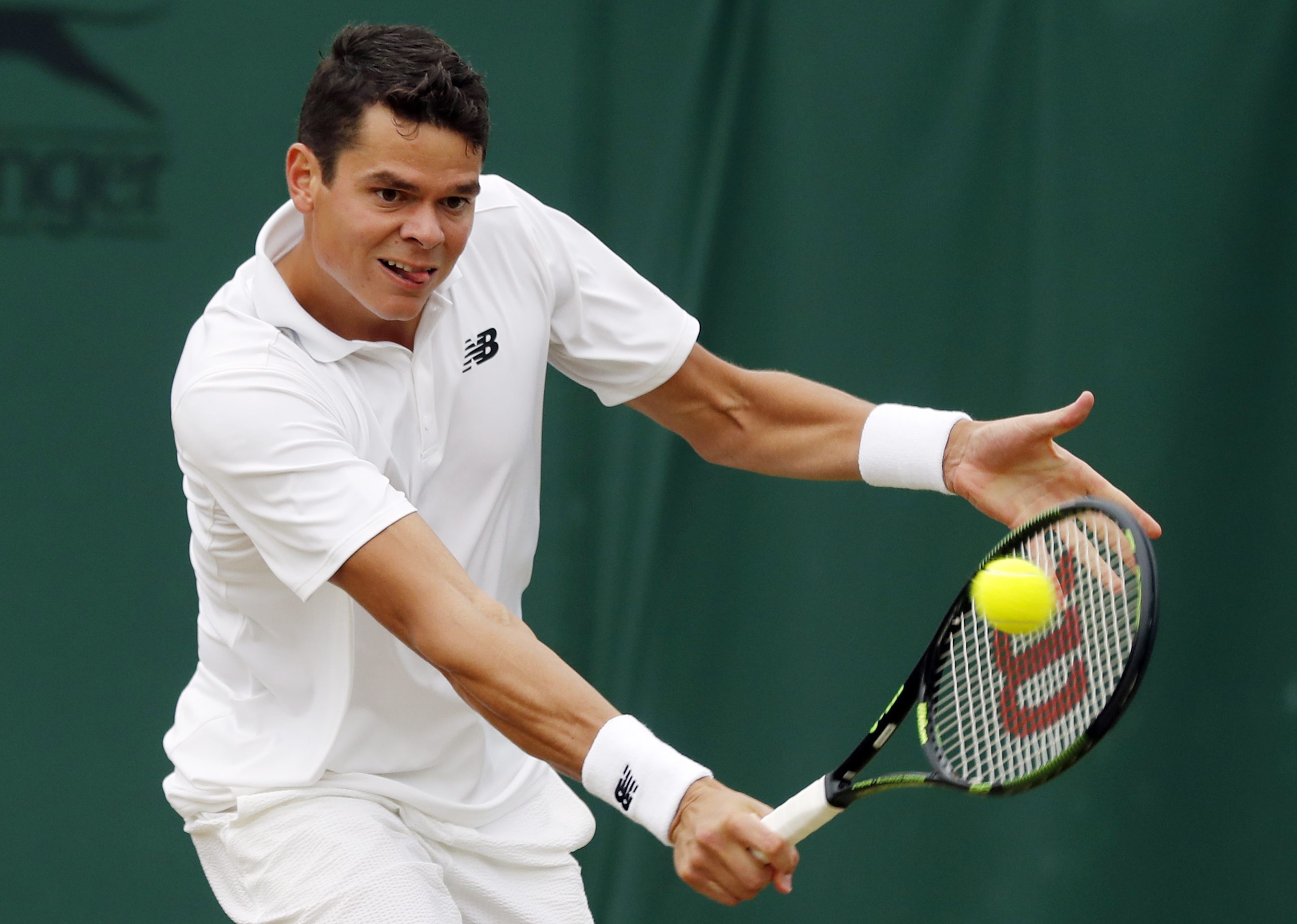 Milos Raonic of Canada returns to David Goffin of Belgium during their men's singles match on day eight of the Wimbledon Tennis Championships in London, Monday, July 4, 2016. (AP Photo/Ben Curtis)