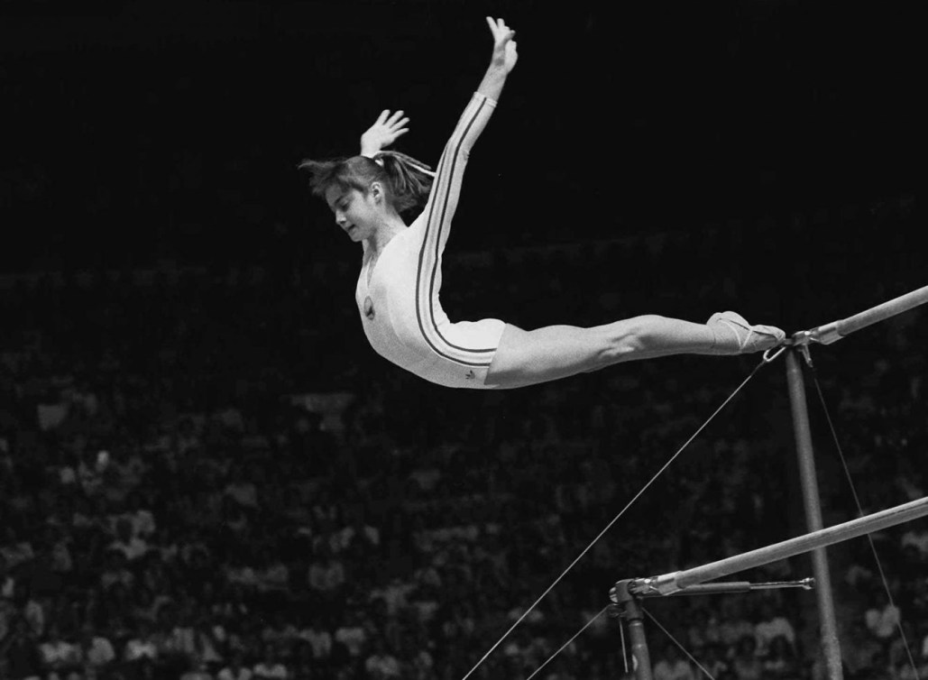 Nadia Comaneci, of Romania, dismounts from the uneven parallel bars during a perfect "10" performance at the Summer Olympics in Montreal, in this July 18, 1976 photo. (AP Photo/Paul Vathis)