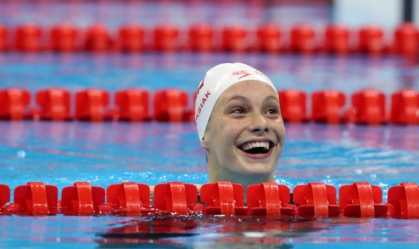 Canada's Penny Oleksiak smiles after winning the gold medal and setting a new olympic record in the women's 100-meter freestyle during the swimming competitions at the 2016 Summer Olympics, Thursday, Aug. 11, 2016, in Rio de Janeiro, Brazil. (AP Photo/Lee Jin-man)